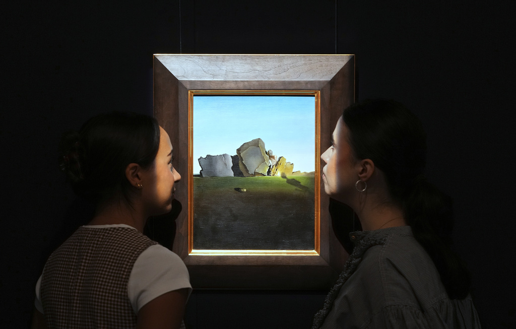 A painting by Salvador Dali called Symbiose de la tete aux coquillages is displayed at Sotheby's auction rooms, the painting estimated at 2-3 million US dollars is part of a collection of surrealist masterpieces unveiled in London ahead of their sale in New York, Friday, Sept. 19, 2025. (AP Photo/Kirsty Wigglesworth)