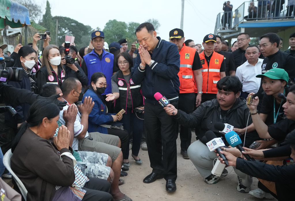 Thailand's Prime Minister Anutin Charnvirakul meets relatives of the victims as he visits the site where a construction crane fell onto a passenger train in Nakhon Ratchasima province, Thailand, Wednesday, Jan. 14, 2026. (AP Photo/Sakchai Lalit)