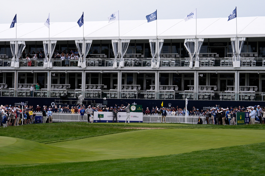 Scottie Scheffler hits on the 18th hole during practice before the PGA Championship golf tournament at the Aronimink Golf Club Monday, May 11, 2026, in Newtown Square, Pa. (AP Photo/Matt Slocum)