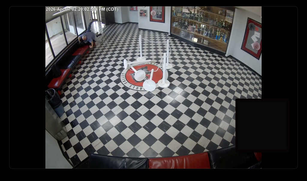 In this image taken from surveillance video released by Pauls Valley Public Schools, principal Kirk Moore can be seen struggling with Victor Hawkins, a former student who allegedly carried a firearm onto the campus on Tuesday, April 7, 2026 in Pauls Valley, Oklahoma. (Pauls Valley Public Schools via AP)