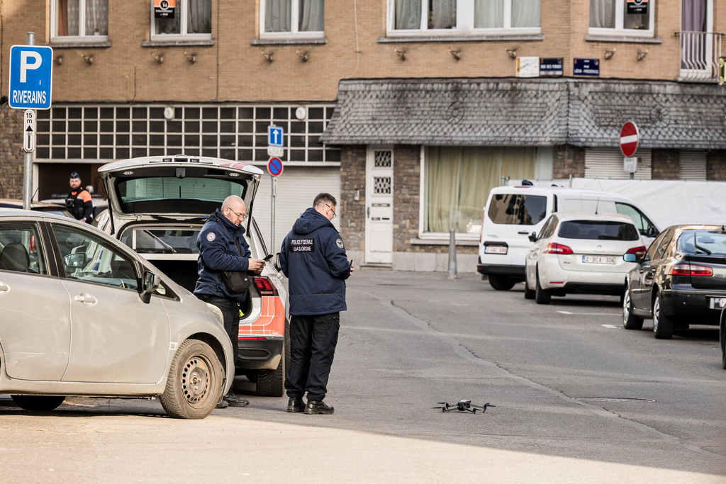 Police prepare to fly a drone in a secure area after a blast took place near a synagogue, in Liege, Belgium, Monday, March 9, 2026. (AP Photo/Valentin Bianchi)