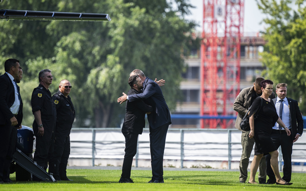 Ukrainian President Volodymyr Zelenskyy, center left, is welcomed by German Chancellor Friedrich Merz upon arrival in the garden of the chancellery in Berlin, Germany, Wednesday, Aug. 13, 2025 to join a video conference of European leaders with the U.S. President on the Ukraine war. (John MacDougall/Pool Photo via AP)