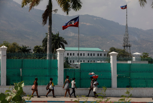 FILE - People walk past the National Palace in Port-au-Prince, Haiti, March 25, 2024. (AP Photo/Odelyn Joseph, File) FILE - People walk past the National Palace in Port-au-Prince, Haiti, March 25, 2024. (AP Photo/Odelyn Joseph, File)