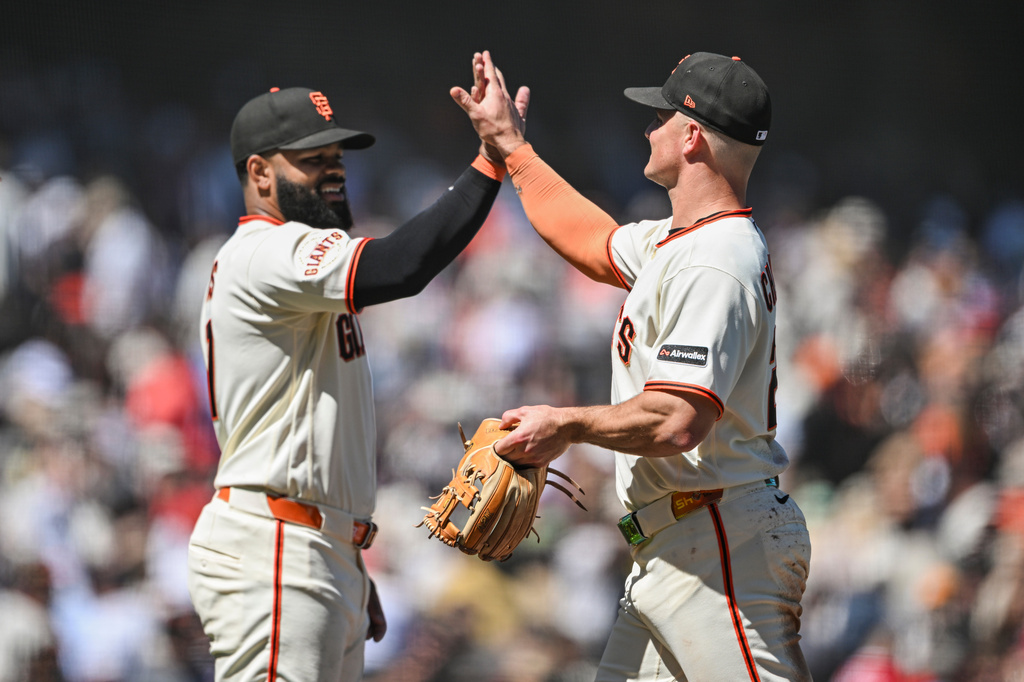 San Francisco Giants' Heliot Ramos, left, and Matt Chapman, right, celebrate after their team defeated the Atlanta Braves in a baseball game, Sunday, June 28, 2026, in San Francisco (AP Photo/Justine Willard)