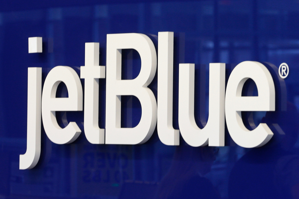 FILE - The JetBlue logo is seen at the check-in counter at the Richmond International Airport in Sandston, Va., Oct. 17, 2019. (AP Photo/Steve Helber, File)