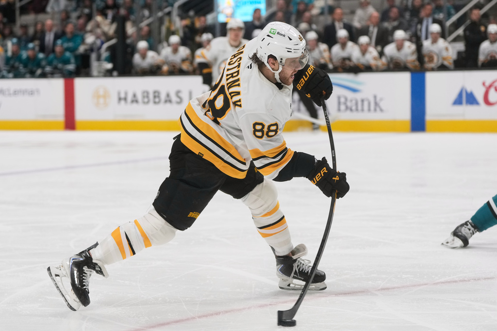 Boston Bruins right wing David Pastrnak (88) shoots the puck against the San Jose Sharks during the second period of an NHL hockey game in San Jose, Calif., Sunday, Nov. 23, 2025. (AP Photo/Jeff Chiu)
