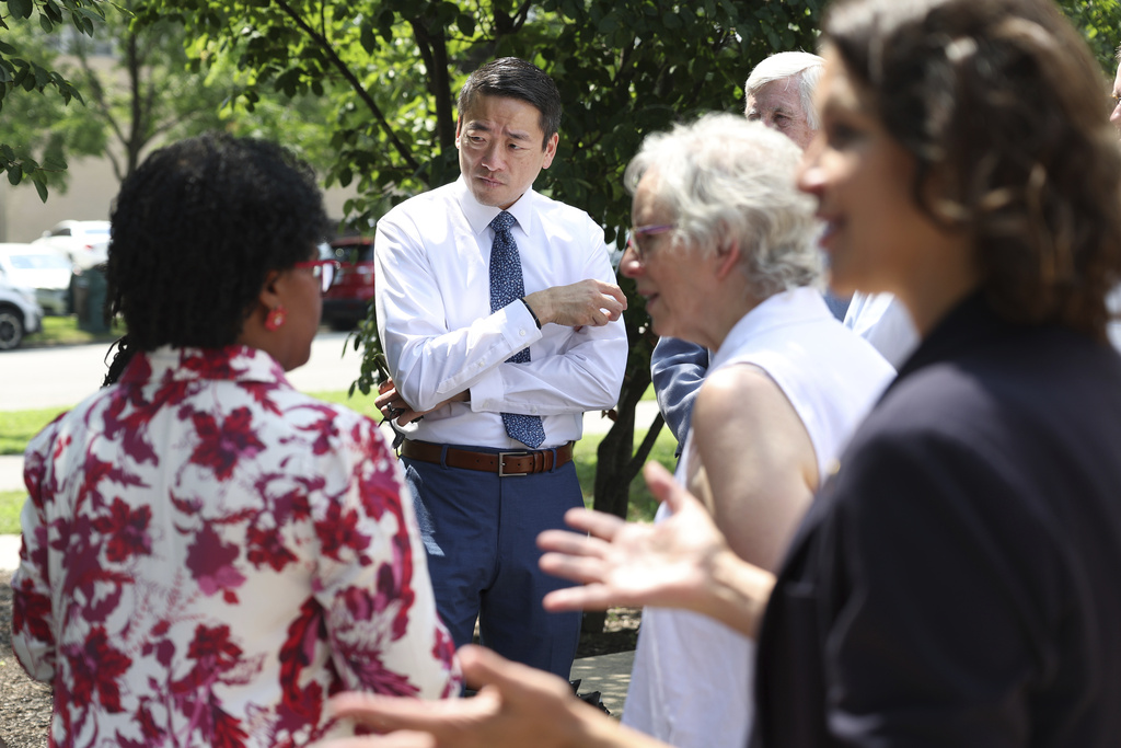 Texas State Rep. Gene Wu, D-Houston, center, talks to Democrat politicians from Indiana, in Chicago, Wednesday, Aug. 13, 2025, before other Texas politicians arrive for a press conference as the Texas Democrats continue to try to prevent a redistricting effort by Republicans in their state. (Terrence Antonio James/Chicago Tribune via AP)