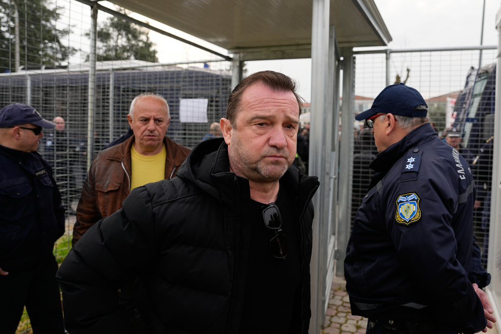 Nikos Plakias father who lost twin daughters, Thomi and Chrysa, and their cousin, Anastasia, victims of the Tempi train crash, arrive at the court in Larissa, Greece, Monday, March 23, 2026. (AP Photo/Thanassis Stavrakis)