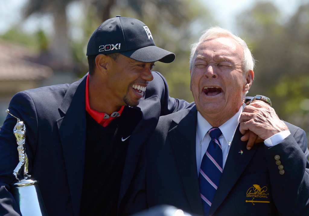 FILE - Tiger Woods, left, and Arnold Palmer share a laugh during the trophy presentation after Woods won the Arnold Palmer Invitational golf tournament, in Orlando, Fla., Monday, March 25, 2013. (AP Photo/Phelan M. Ebenhack, File)