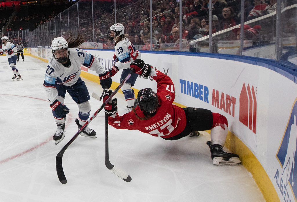 United States' Abbey Murphy (37) checks Canada's Ella Shelton (17) during the second period of Rivalry Series game in Edmonton on Wednesday, Dec. 10, 2025. (Jason Franson/The Canadian Press via AP)