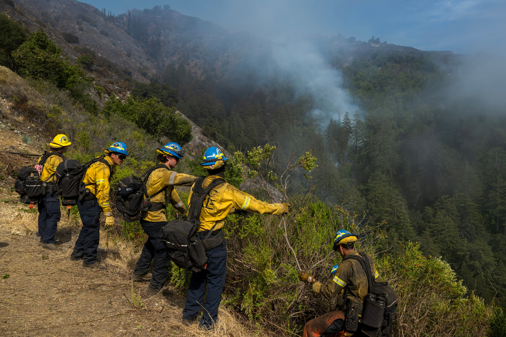 Crews clear brush above Castro Canyon as the Timber Fire burns in Big Sur, Calif., Tuesday, Aug. 11, 2026. (AP Photo/Nic Coury)