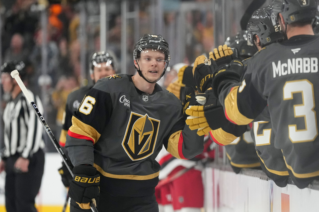 Vegas Golden Knights right wing Pavel Dorofeyev, center, celebrates after his goal against the Carolina Hurricanes during the first period of an NHL hockey game Monday, Oct. 20, 2025, in Las Vegas. (AP Photo/Candice Ward)