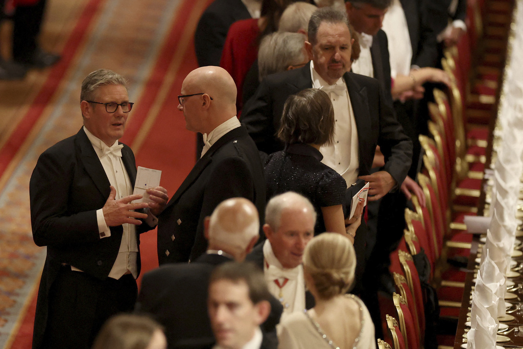 Britain's Prime Minister Keir Starmer, left, arrives for a State Banquet at Windsor Castle, in Windsor, England, Sept. 17, 2025. (Phil Noble/Pool Photo via AP)
