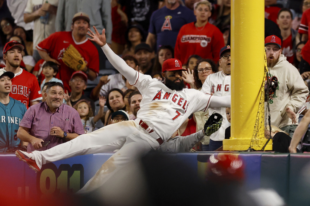 Los Angeles Angels left fielder Jo Adell (7) catches a ball hit by Seattle Mariners' J.P. Crawford during the ninth inning of a baseball game Saturday, April 4, 2026, in Anaheim, Calif. (AP Photo/Caroline Brehman)