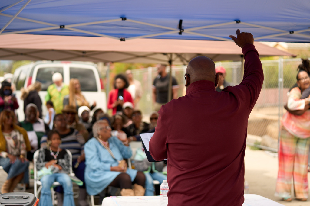 Pastor Jonathan Lewis holds a groundbreaking service at the site of the burned Fountain of Life Nazarene Church to mark the beginning of its rebuilding in Altadena, Calif., April 26, 2026. (AP Photo/Damian Dovarganes)
