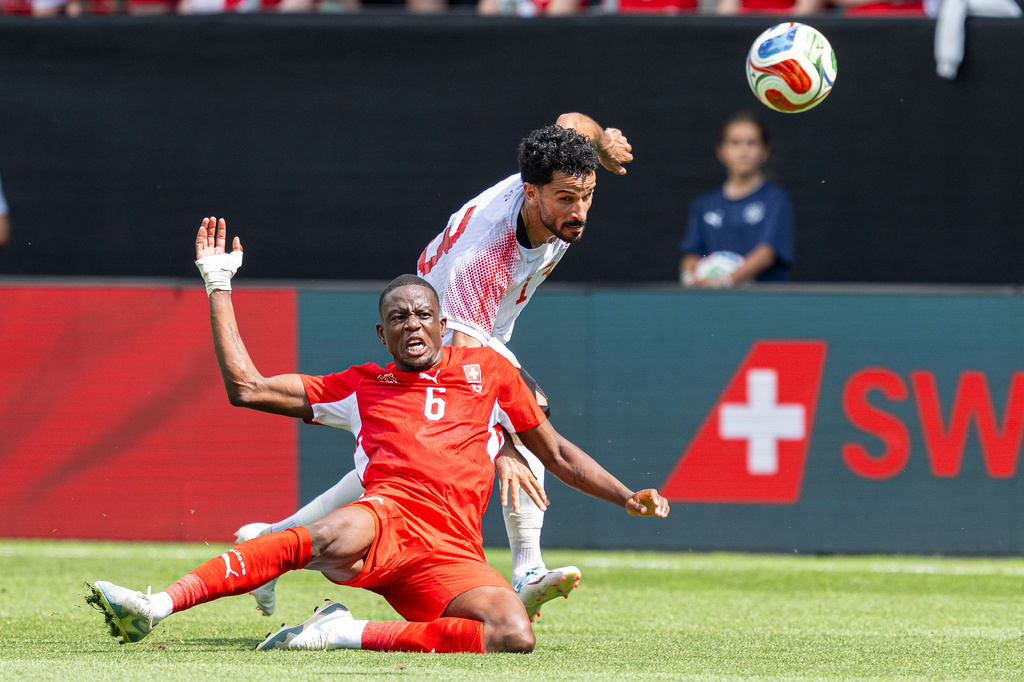 Switzerland's Denis Zakaria, left, fights for the ball with Jordan's Mahmoud Al-Mardiduring the international friendly soccer match between Switzerland and Jordan in St. Gallen, Switzerland, Sunday, May 31, 2026. (Peter Schneider/Keystone via AP)