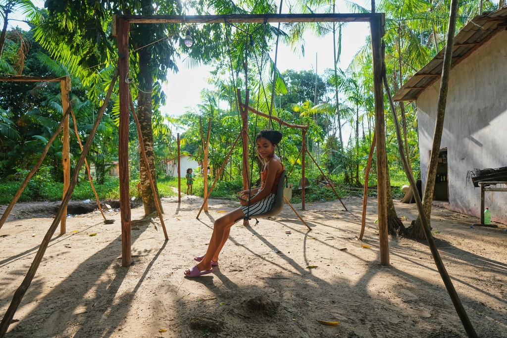 A girl plays in a park in Itacoa Miri, Brazil, Tuesday, Nov. 18, 2025. (AP Photo/Fernando Llano)