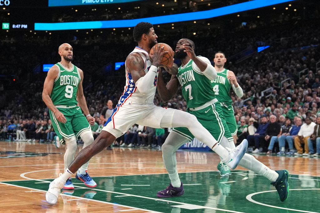FILE - Philadelphia 76ers forward Paul George (8) drives to the basket against Boston Celtics guard Jaylen Brown (7) during the second half of Game 2 of a first-round NBA playoffs basketball series, April 21, 2026, in Boston. (AP Photo/Charles Krupa, File)