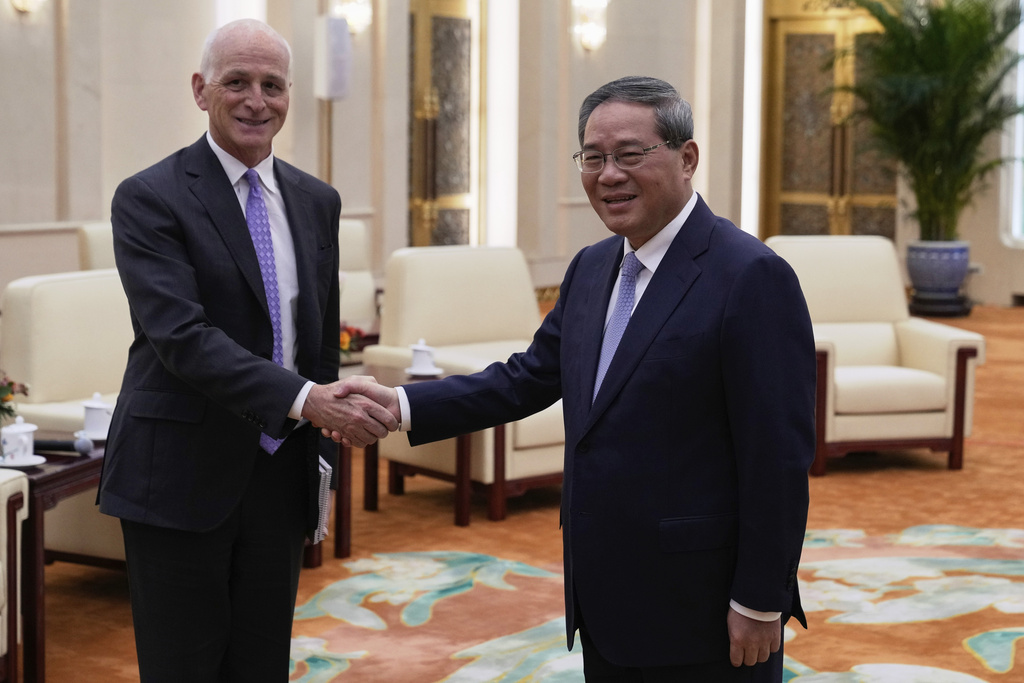 Rep. Adam Smith, D-Wash, left, shakes hands with Chinese Premier Li Qiang as he leads a bipartisan group of U.S. lawmakers for a meeting at the Great Hall of the People in Beijing, China, Sunday, Sept. 21, 2025. (AP Photo/Mahesh Kumar A., Pool)