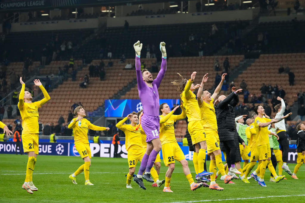 Glimt's players celebrate at the end of the Champions League playoff soccer match between Inter Milan and Bodo Glimt, at the San Siro stadium in Milan, Italy, Tuesday, Feb.24, 2026. (AP Photo/Luca Bruno)