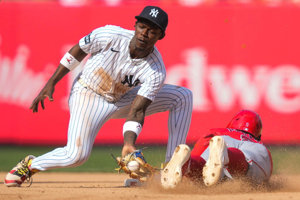New York Yankees second baseman Jazz Chisholm Jr. (13) fails to tag out Los Angeles Angels' Oswald Peraza (2) at second base during the inning of a baseball game, Thursday, April 16, 2026, in New York. (AP Photo/Yuki Iwamura)