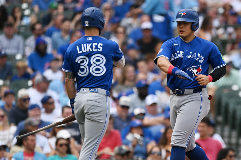 Toronto Blue Jays' Kazuma Okamoto, of Japan, right, celebrates with teammate Nathan Lukes (38) after scoring on a disengagement violation during the first inning of a baseball game against the Chicago Cubs in Chicago, Thursday, Aug. 6, 2026. (AP Photo/Paul Beaty)