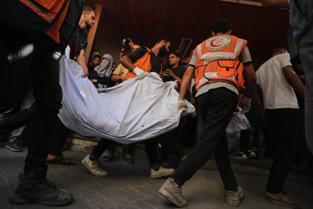 The bodies of Palestinians, killed by Israeli fire after crossing the ceasefire line according to the Hamas-run Civil Defense, are brought to Al Ahli Hospital in Gaza City, Saturday, Oct. 18, 2025. (AP Photo/Yousef Al Zanoun)