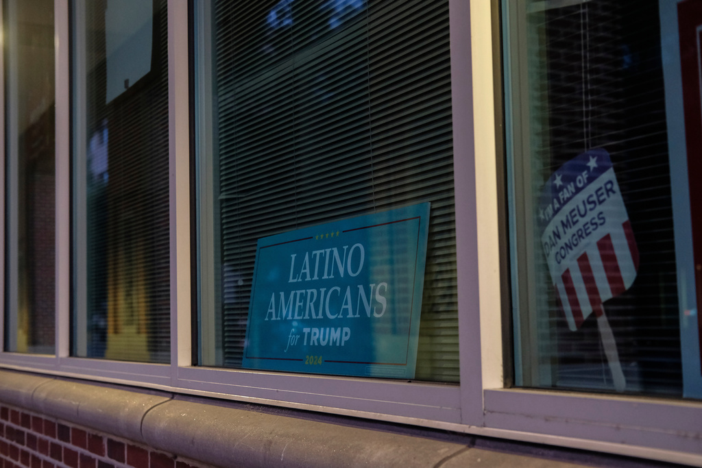 FILE - A sign is displayed at the Latino Americans for Trump office in Reading, Pa., June 16, 2024. (AP Photo/Luis Andres Henao, File)