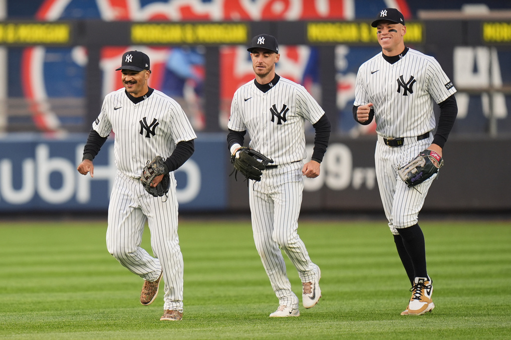 New York Yankees outfielders Trent Grisham, left, Cody Bellinger, center, and Aaron Judge celebrate after a baseball game against the Kansas City Royals, Sunday, April 19, 2026, in New York. (AP Photo/Seth Wenig)