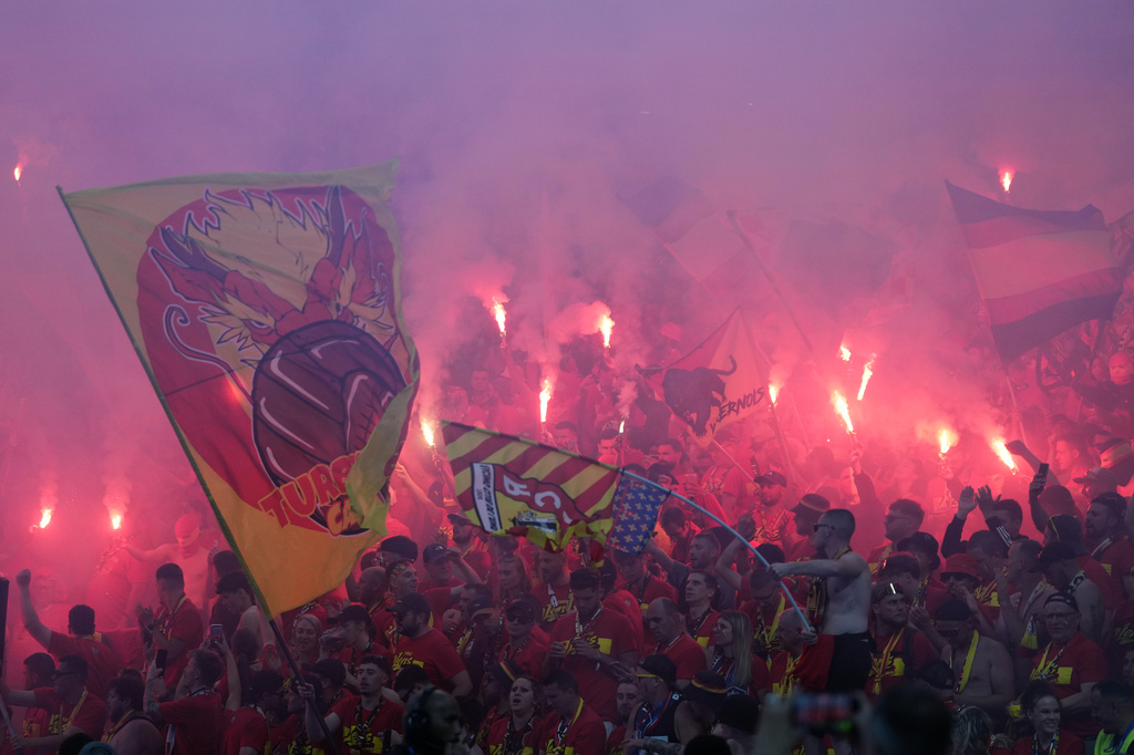 Lens' supporters wave their flags during the French Cup soccer final between Nice and Lens in Saint-Denis, outside Paris, Friday, May 22, 2026. (AP Photo/Thibault Camus)