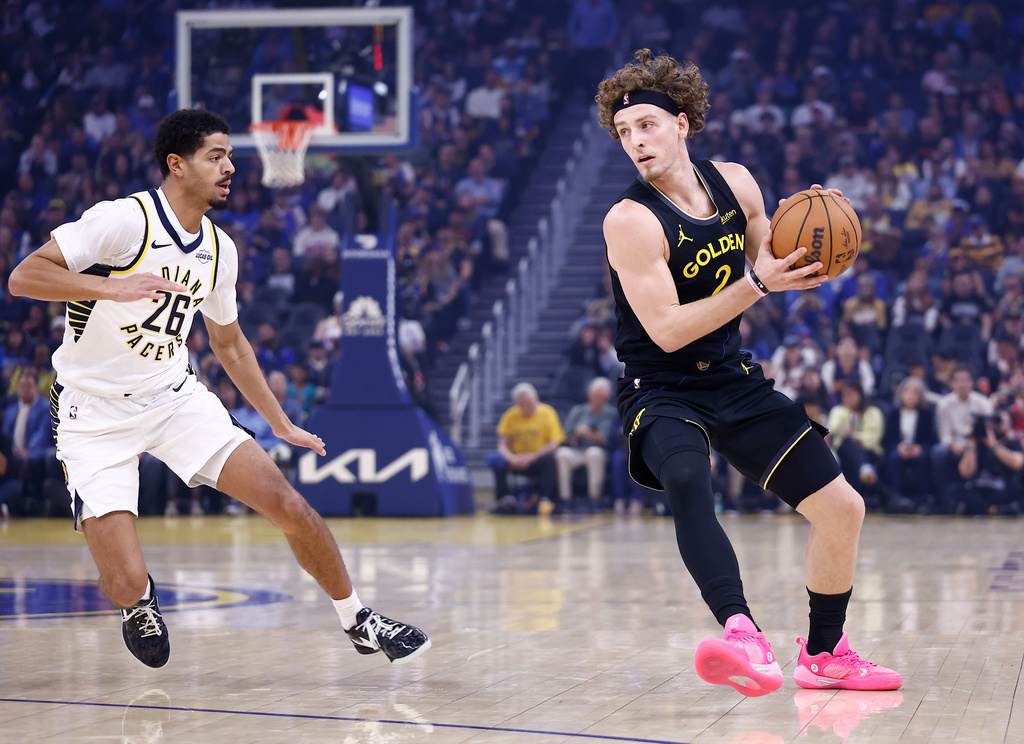 Golden State Warriors guard Brandin Podziemski (2) controls the ball against Indiana Pacers guard Ben Sheppard (26) during the first half of an NBA basketball game Sunday, Nov. 9, 2025, in San Francisco. (AP Photo/Kelley L Cox)