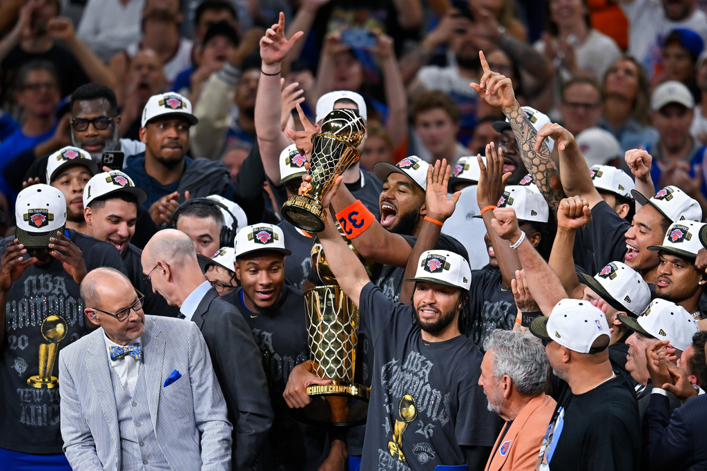 New York Knicks guard Jalen Brunson holds the MVP trophy after the Knicks defeated the San Antonio Spurs in Game 5 of the NBA Finals basketball series, Saturday, June 13, 2026, in San Antonio. (AP Photo/Darren Abate)