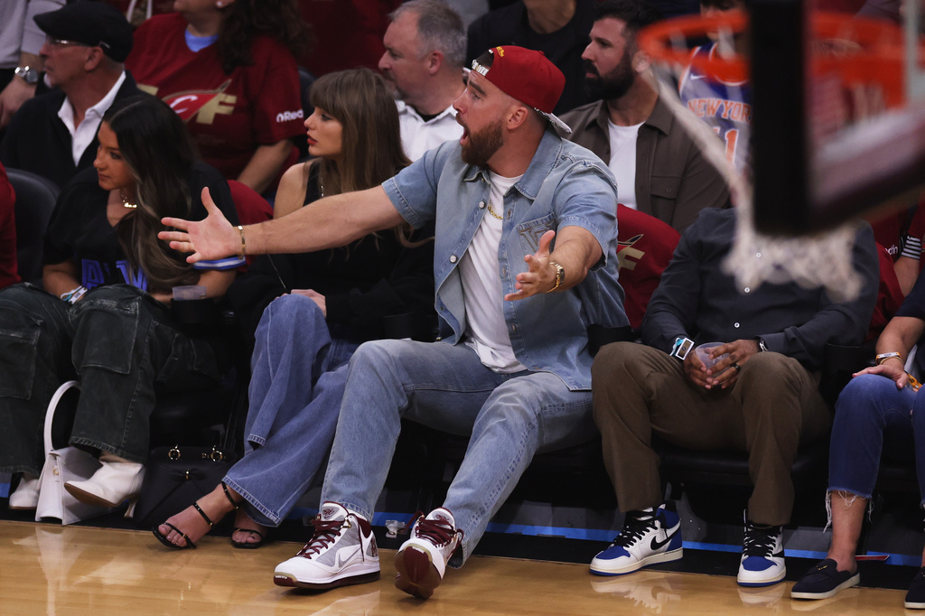 Taylor Swift and Travis Kelce watch the first half of Game 3 in the Eastern Conference finals NBA basketball playoffs series between the New York Knicks and the Cleveland Cavaliers in Cleveland, Saturday, May 23, 2026. (AP Photo/Tim Phillis)