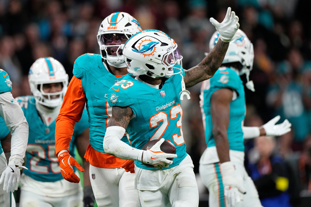 Miami Dolphins cornerback Jack Jones (23) celebrates after making an interception during overtime of an NFL football game between the Washington Commanders and the Miami Dolphins in Madrid, Spain, Sunday, Nov. 16, 2025. (AP Photo/Bernat Armangue)