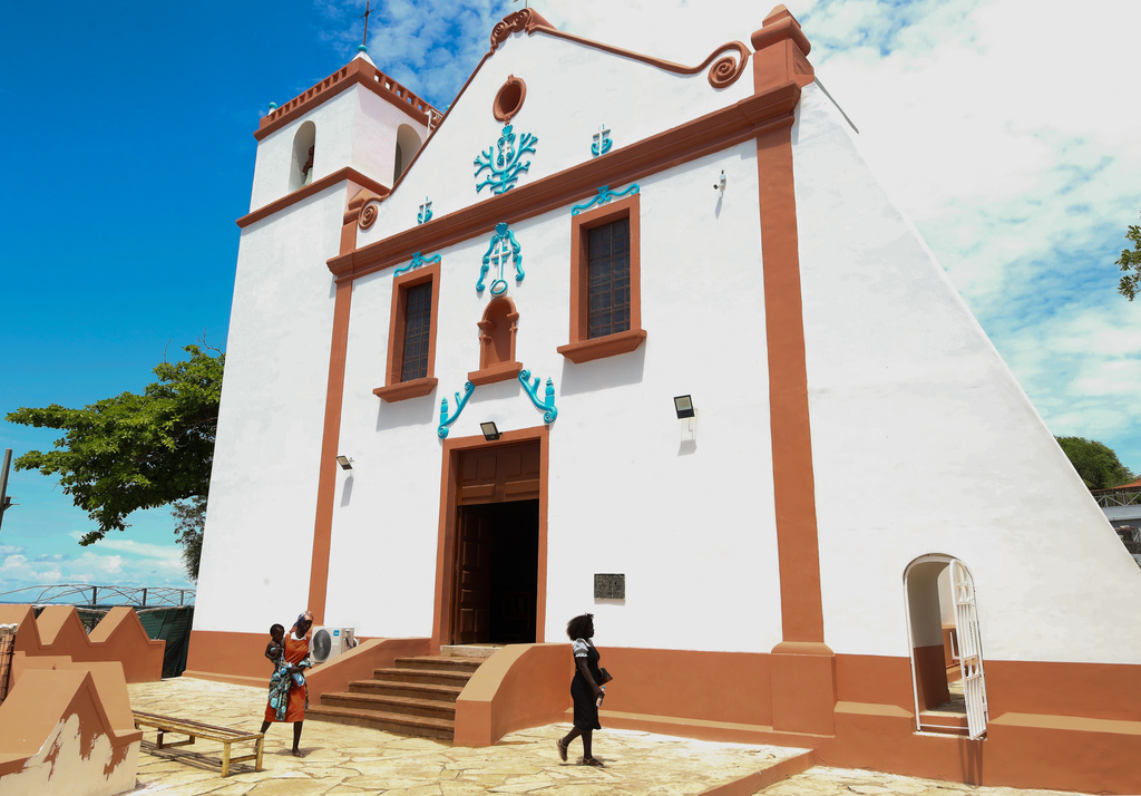 People walk by the Church of Our Lady of Muxima in Muxima, Angola, Saturday, April 11, 2026, which Pope Leo XIV will visit during his 11-day pastoral visit to Africa. (AP Photo)