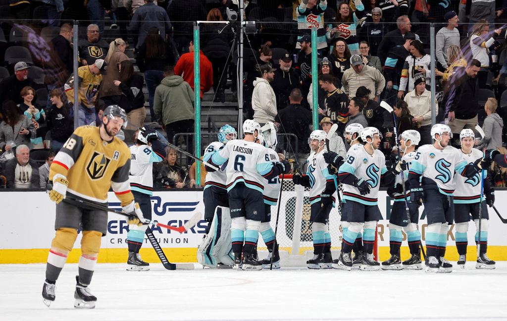 Vegas Golden Knights center Tomas Hertl (48) skates away as members of the Seattle Kraken celebrate a win over the Vegas Golden Knights in an NHL hockey game Saturday Jan. 31, 2026, in Las Vegas. (AP Photo/Steve Marcus)