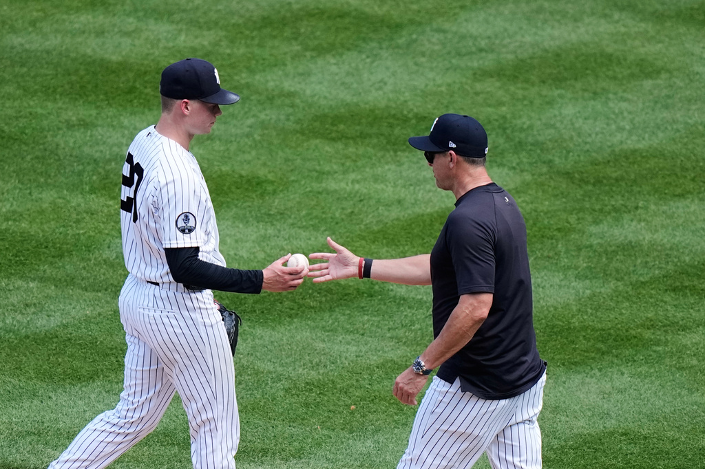 New York Yankees' Will Warren hands the ball to manager Aaron Boone as he leaves during the sixth inning of a baseball game against the Detroit Tigers Wednesday, July 1, 2026, in New York. (AP Photo/Frank Franklin II)