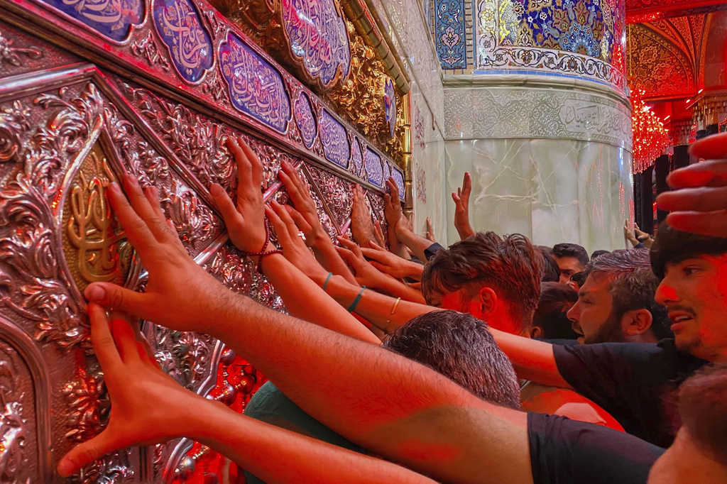 Shiite pilgrims mark the holiday of Arbaeen inside the holy shrine of Imam Hussein, which marks the end of the 40-day mourning period following Ashura, in Karbala, Iraq, Thursday, Aug. 15, 2025. (AP Photo/Hadi Mizban)