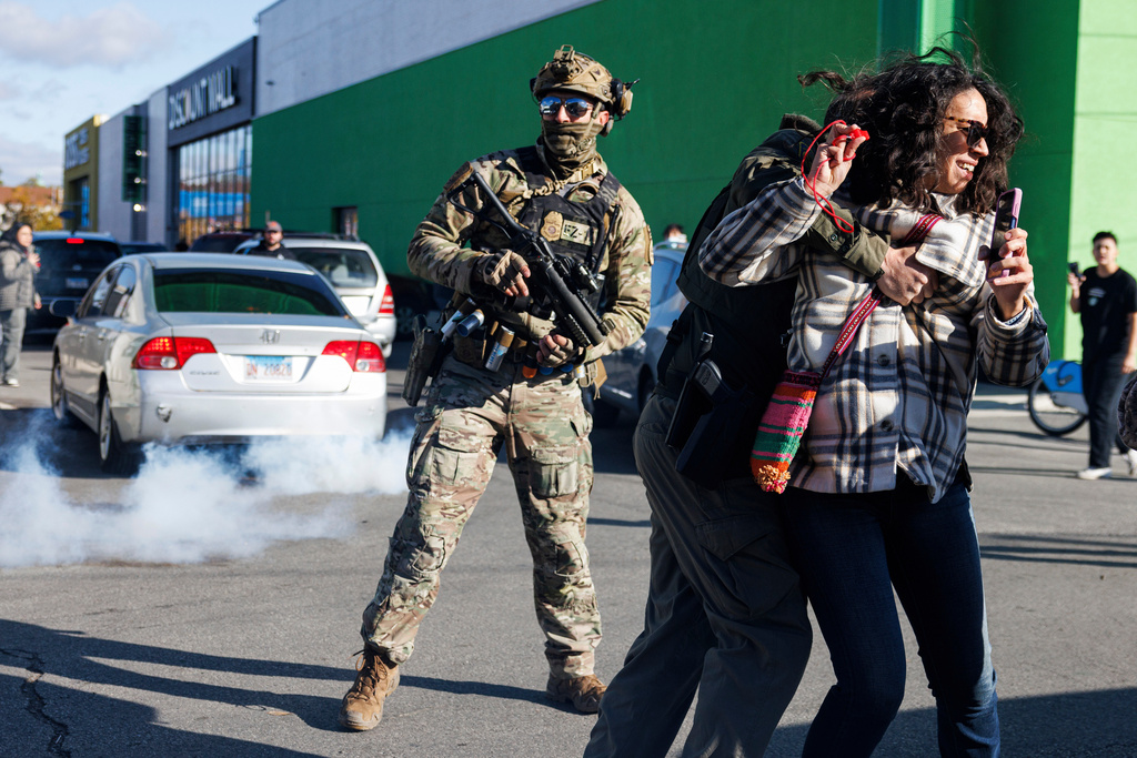 FILE - Federal immigration enforcement agents detain a protester in the Little Village neighborhood of Chicago on Thursday, Oct. 23, 2025. (Anthony Vazquez/Chicago Sun-Times via AP, File)