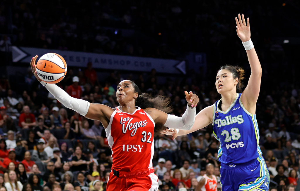 Las Vegas Aces forward Cheyenne Parker-Tyus (32) catches a pass ahead of Dallas Wings center Li Yueru (28) during the first half of an WNBA basketball game Thursday, June 25, 2026, in Las Vegas. (Steve Marcus/Las Vegas Sun via AP)