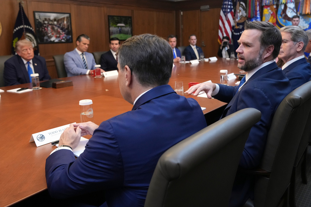 Vice President JD Vance speaks as Treasury Secretary Scott Bessent, right, acting Attorney General Todd Blanche, foreground left, and President Donald Trump, background left, listen during a cabinet meeting, Friday, July 31, 2026, at Camp David, the presidential retreat, near Thurmont, Md., Friday, July 31, 2026. (AP Photo/Jacquelyn Martin)