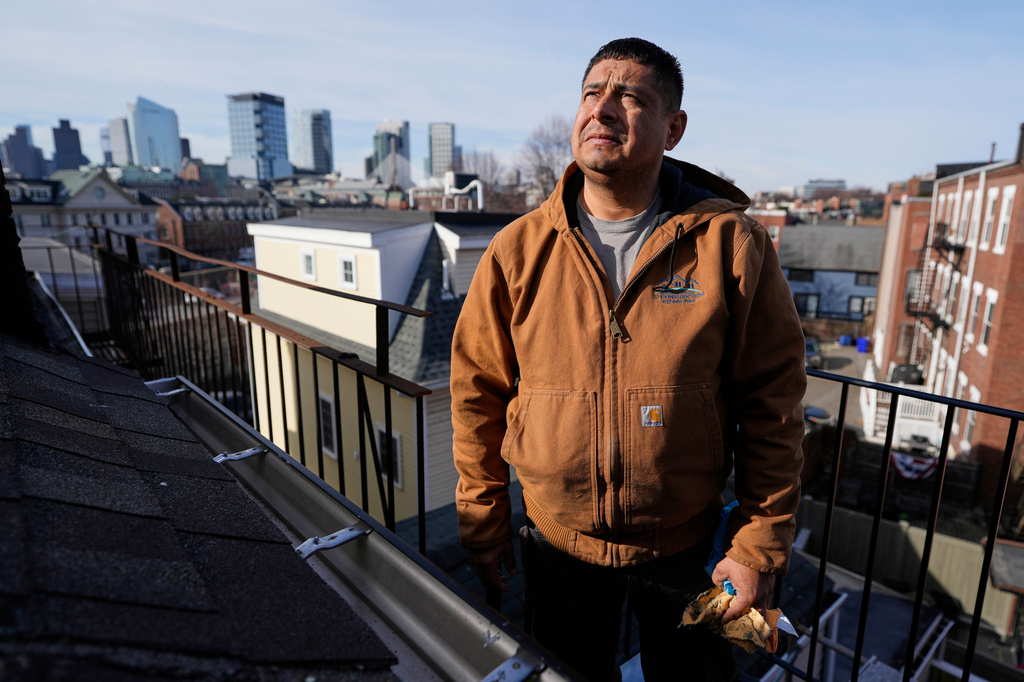 General contractor Jose Urias, a Salvadoran who has had Temporary Protected Status in the U.S. since 2001, inspects the roof of a high-end apartment his crew is remodeling, Wednesday, March 25, 2026, in Charleston, Mass. (AP Photo/Robert F. Bukaty)