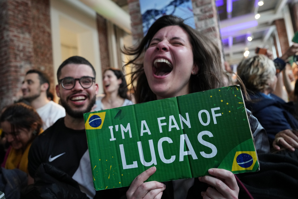 Supporters of Brazil's Lucas Pinheiro Braathen react at the Brazil House as he wins the men's giant slalom at the 2026 Winter Olympics, in Milan, Italy, Saturday, Feb. 14, 2026. (AP Photo/Antonio Calanni)