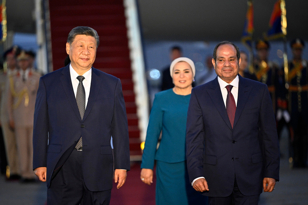 Chinese President Xi Jinping, left, and his wife Peng Liyuan, covered, is welcomed by Egyptian President Abdel-Fattah el-Sissi, right, and his wife Entissar Amer, at Cairo International Airport in Cairo, Egypt, Tuesday, Sept. 1, 2026. (Khaled Desouki/Pool Photo via AP)