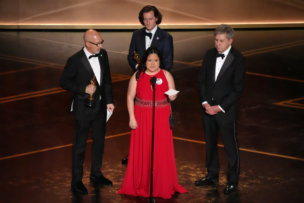 Joshua Seftel, from left, Gloria Cazares, Conall Jones, and Steve Hartman accept the award for documentary short film for "All the Empty Rooms" during the Oscars on Sunday, March 15, 2026, at the Dolby Theatre in Los Angeles. (AP Photo/Chris Pizzello)