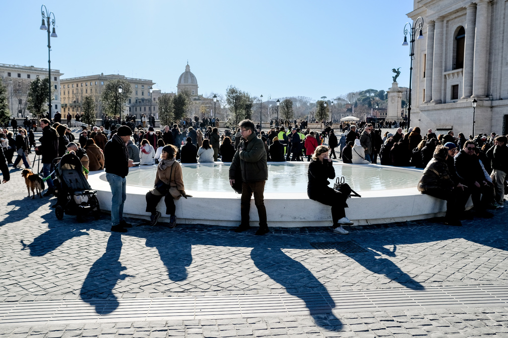FILE - People sit on a fountain after the inauguration of the new design of Piazza Pia, a pedestrian piazza at the end of the Via della Conciliazione boulevard, opposite St. Peter's Basilica, Thursday, Dec. 26, 2024. (Mauro Scrobogna/LaPresse via AP, file)