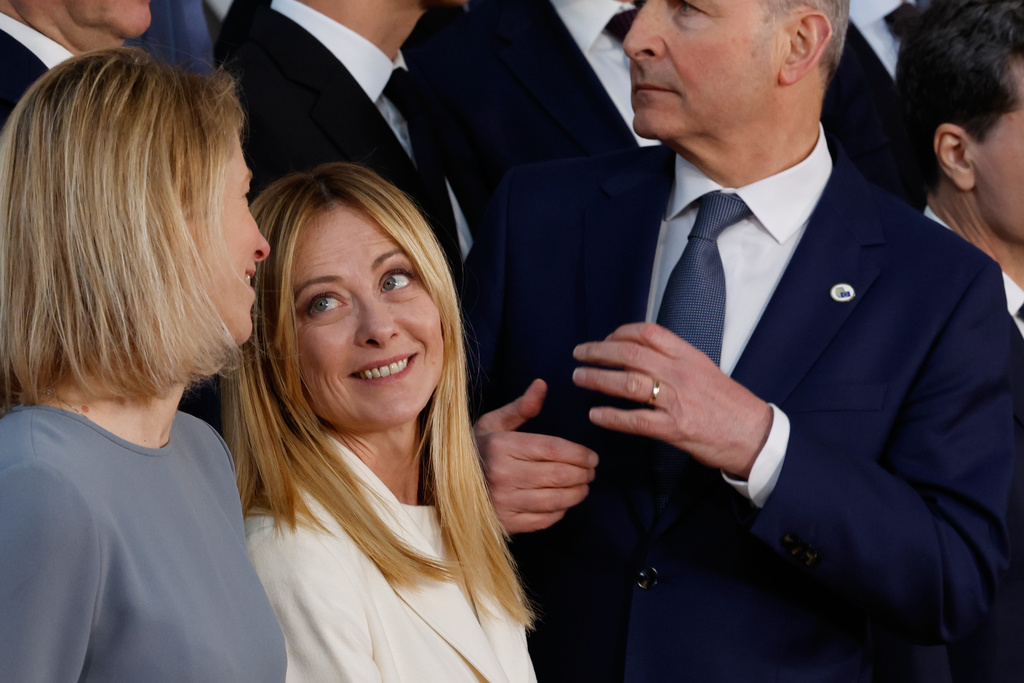 Italy's Prime Minister Giorgia Meloni, center, speaks with European Union foreign policy chief Kaja Kallas, left, during a group photo at an EU summit in Brussels, Thursday, March 19, 2026. (AP Photo/Geert Vanden Wijngaert)