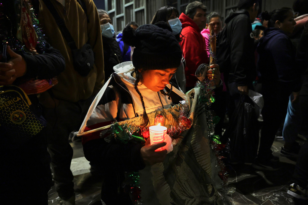 A woman prays inside the Basilica of Our Lady of Guadalupe in Mexico City, on her feast day, Friday, Dec. 12, 2025. (AP Photo/Claudia Rosel)