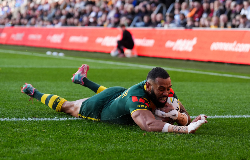 Australia's Josh Addo-Carr scores a try during the rugby League Ashes series match between England and Australia, in Leeds, England, Saturday Nov. 8, 2025. (Mike Egerton/PA via AP)