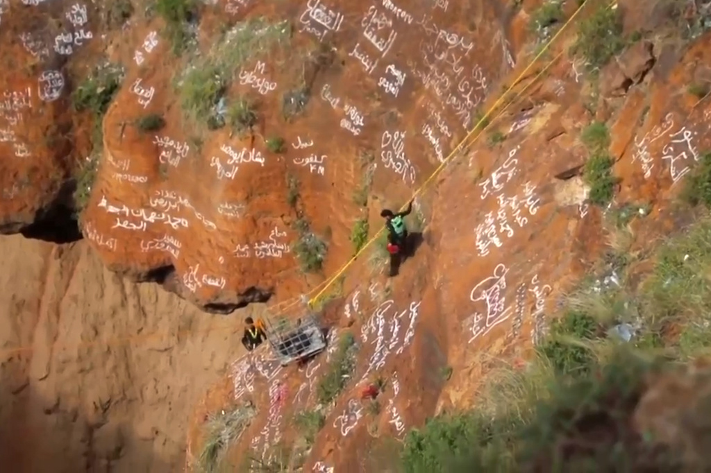 This screengrab from video, released by Yemeni Civil Defense Authority, shows rescuers removing the body of daredevil adventurer Al-Qaqa Ibn Antar on Saturday, June 13, 2026, after he had fallen into a volcanic crater in southern Yemen while climbing without safety equipment on Friday. (Yemeni Civil Defense Authority via AP)